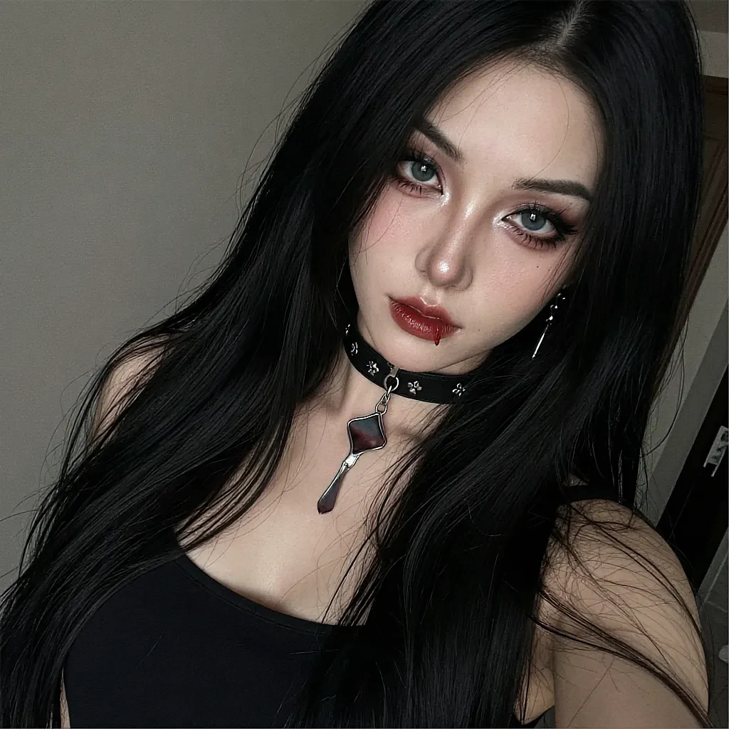 Long black hair, blue eyes, red lips, spiked leather choker with pendant, black tank top